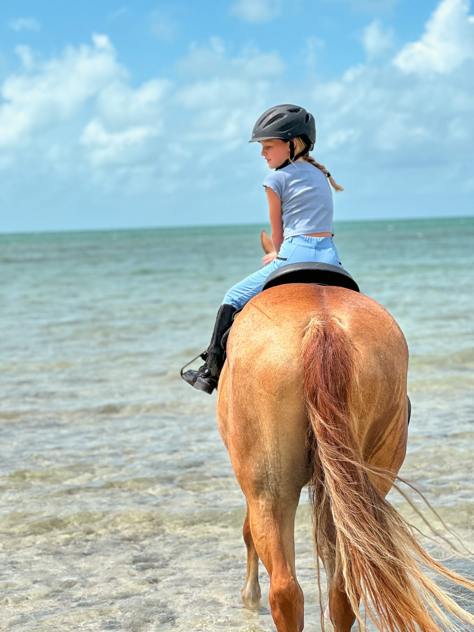 Young rider on horseback with safety gear at Ranch Resort